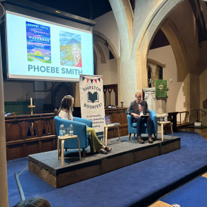 Phoebe Smith sits on stage with James MacDonald Lockhart